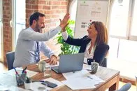 Two people high fiving